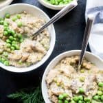 two bowls of creamy chicken with green peas