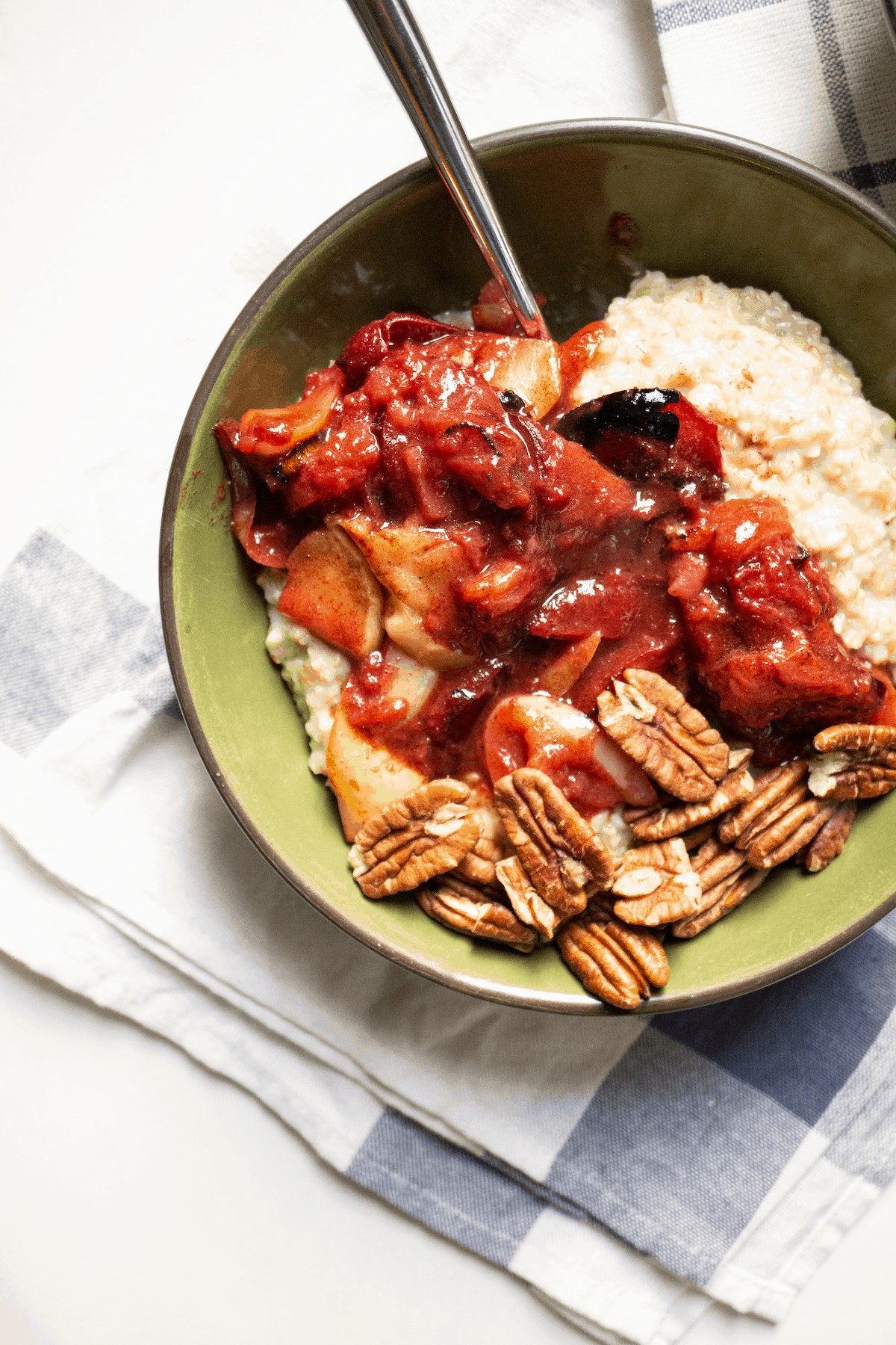 bowl of oatmeal with rhubarb compote and pecans