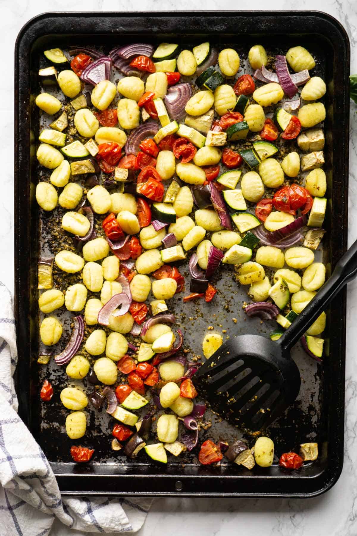 Pesto Gnocchi Sheet Pan dinner with tomatoes, eggplant, zucchini, and red onions