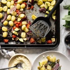 Overview of pesto gnocchi on a sheetpan and served on a plate with a glass of wine and parmesan cheese