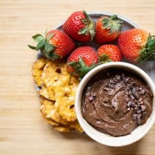 brownie batter hummus in a bowl with pretzel crackers and strawberries