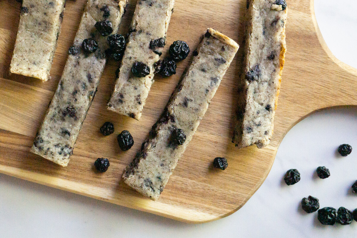 wooden serving board with soft baked blueberry almond snack bars