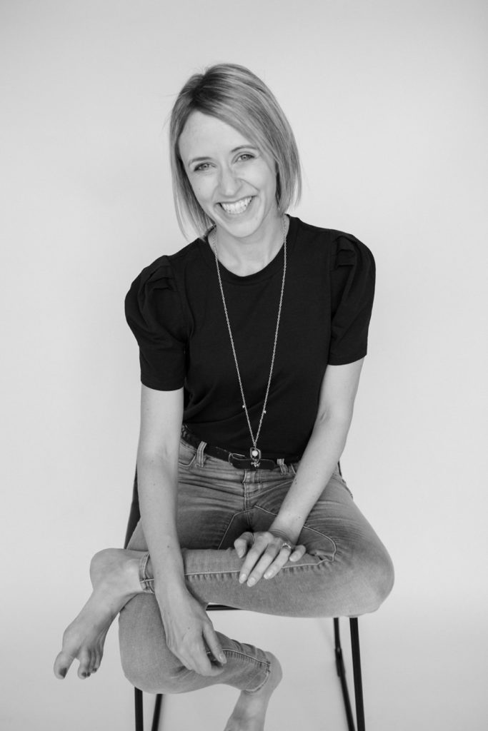 black and white image of jessica penner sitting on a stool