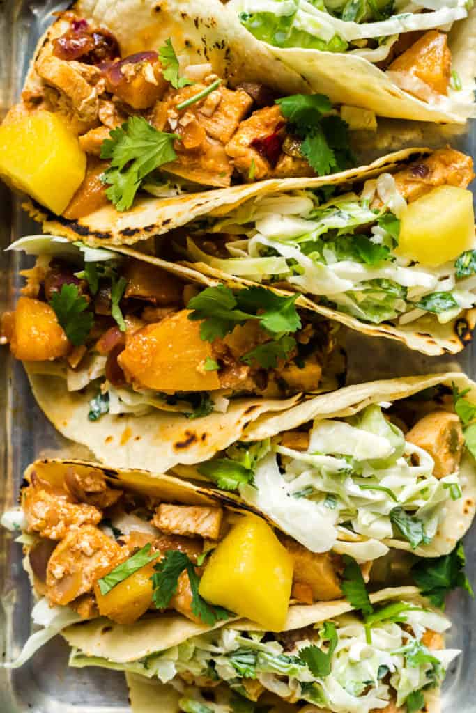 Closeup image of chicken pineapple tacos on a sheet pan