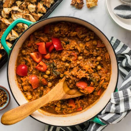 A pot of chorizo chickpea stew with a pan of ciabatta croutons.